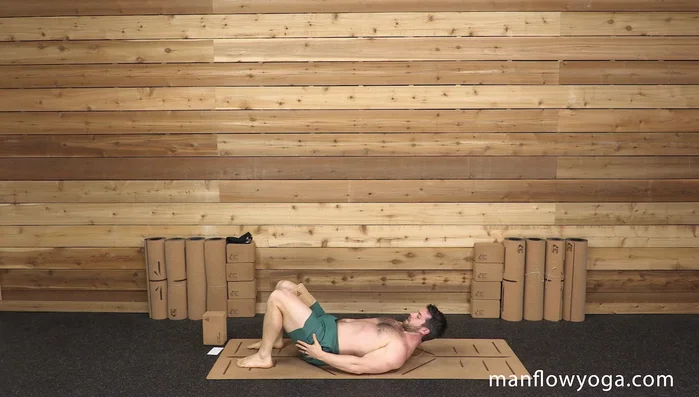 Keep the block between your thighs, squeeze your butt, press down through your feet, and lift your hips into a bridge. Keep your back flat.