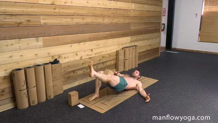 Extend one leg forward, maintaining the bridge position and squeezing the block.