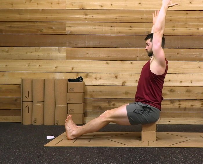 Extend arms overhead, lift chest, squeeze shoulder blades together, and press down through hips.