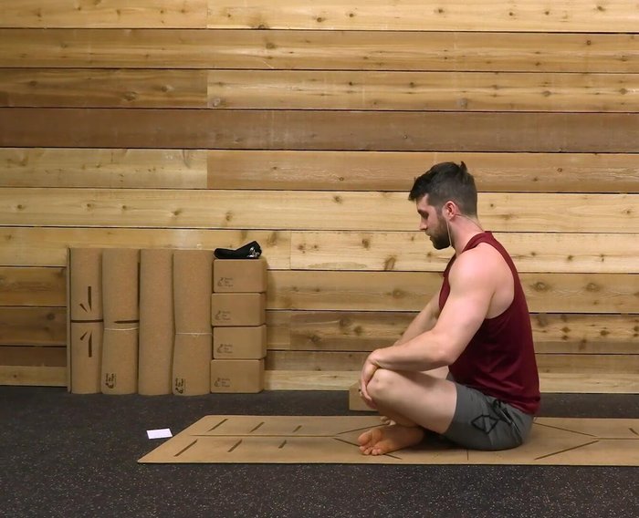 Lift your chest, maintaining an upright posture. You can hold onto your knees for support.
