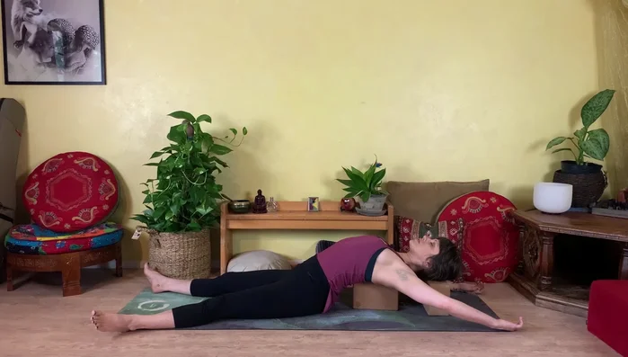 Slowly roll to the side, remove blocks, and roll onto your back. Then roll to your side and sit up.