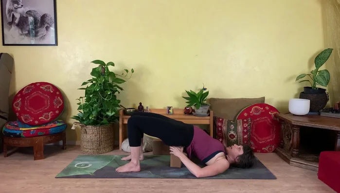 Slowly draw knees back in and lower hips.