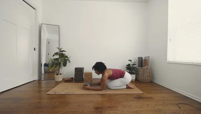 Grip the block and curl your toes, pressing into Dolphin Pose.