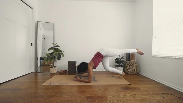 Gently kick up into Forearm Stand, using the block for stability.