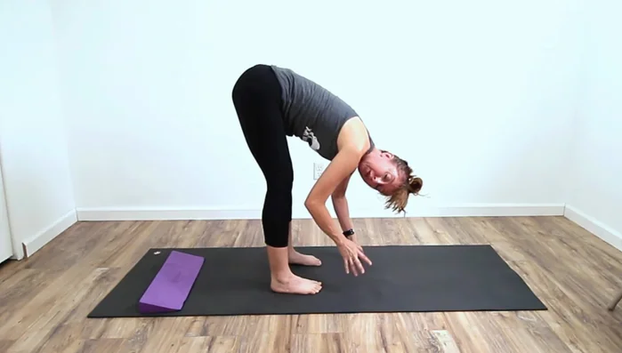 Deepen Forward Fold: Determine if tight hamstrings or calves are limiting your forward fold by using the wedge under your heels. If it allows you to go further, it indicates tight calves.