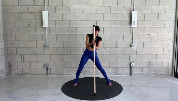 Perform circles with the stick, shifting your weight as you rotate your body. Repeat in both directions.