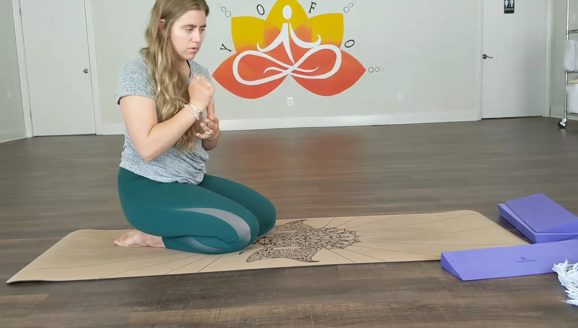 Instructor showing how to use the wedge under hands in tabletop pose