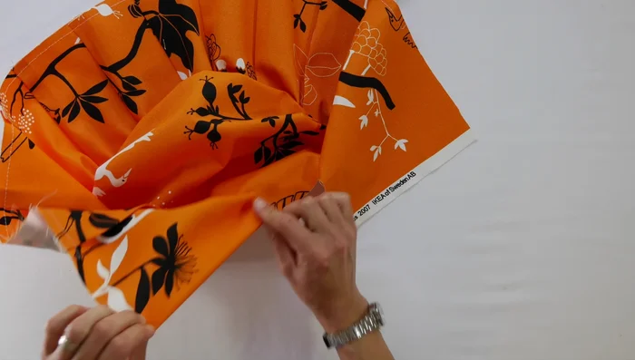 Sew the side to the top/bottom: Sew the pinned edges together using your sewing machine, using a 1/2 inch seam allowance. Press the seam flat.