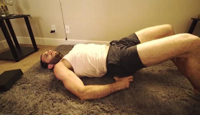 Adjust the block's height as needed for comfort; lower is better. Bring awareness to a slight stretch in your soas muscle (this helps ensure correct positioning).
