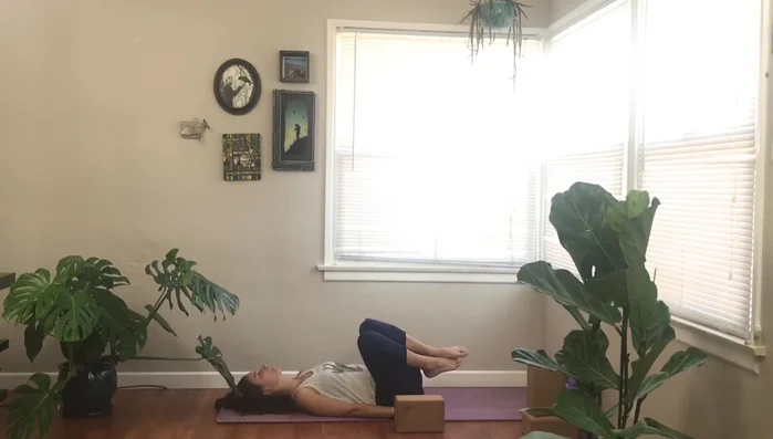 Exhale, one vertebra at a time, all the way down to your back.