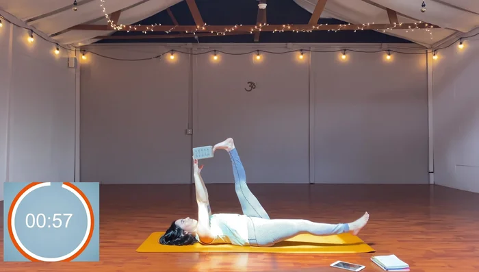 Straddle, reach block through legs, put block in feet, move block side to side.