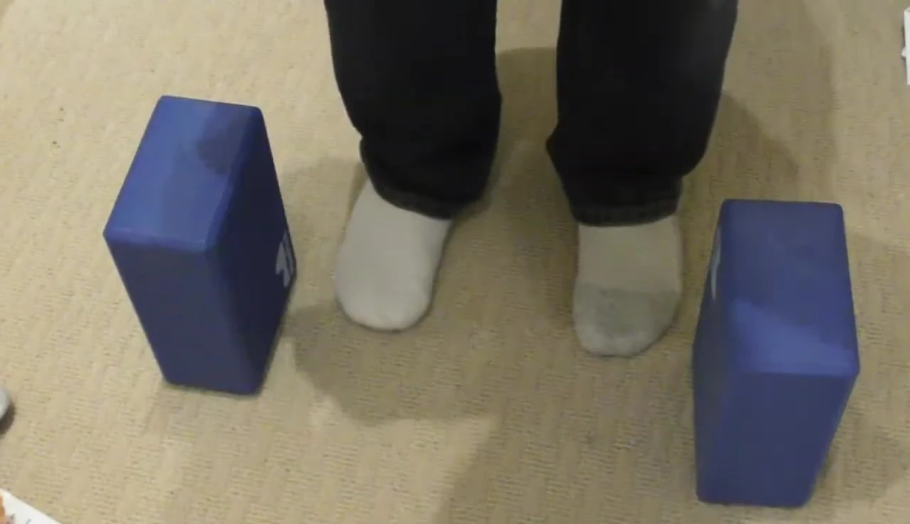Person demonstrating a hamstring stretch without the block.