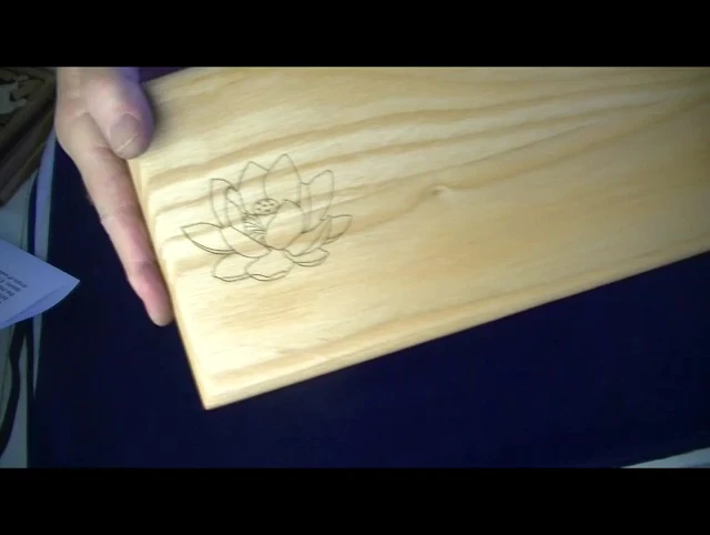 Close-up of the Lotus and Bodhi leaf engravings on the bench.