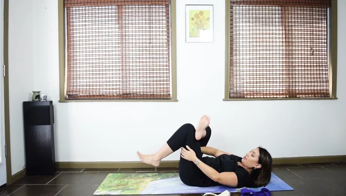 Gently pull on the strap to deepen the stretch, relaxing your shoulders and neck.