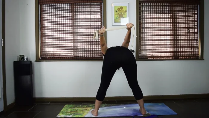 Extend your arms behind you, dropping your chin slightly.