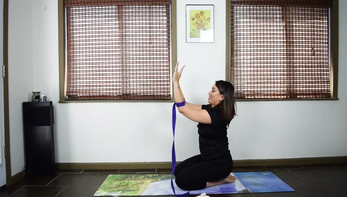 Place the loop around your forearms, actively pulling your forearms away from each other to engage the muscles.