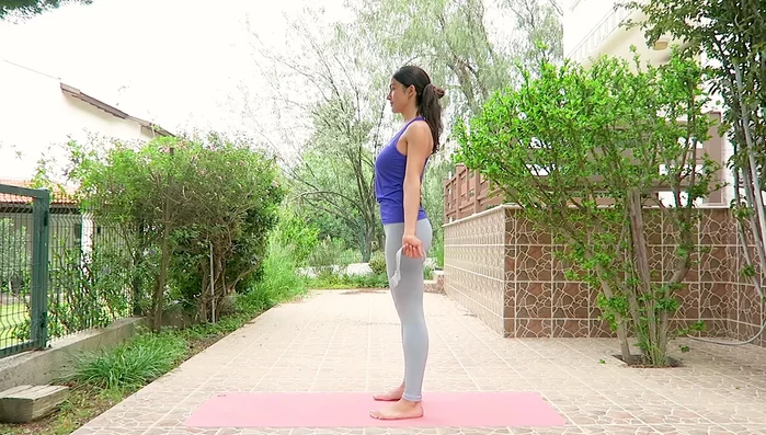 Hold strap behind back, arms extended, posture upright. Inhale, lift arms up; exhale, lower. Repeat. Adjust hand placement if stretch is too intense.