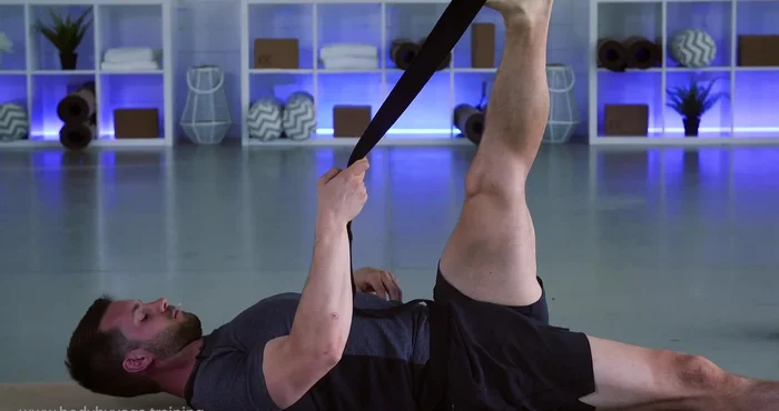 Bring strap over to the right, left hip planted. Stretch outer left thigh and hip, releasing lower back.