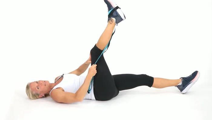 Wrap the strap around the inside of your right leg (opposite of step 3). Bring your leg across your body and back up. Repeat.