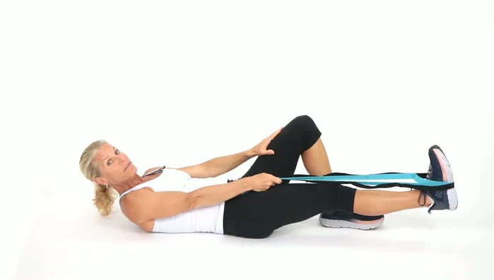 Start with left leg bent, right leg straight. Choke up on the strap (hold it closer to your foot) with your right leg straight. Pull your leg up towards your face, holding for a couple of seconds, then lower it down. Repeat, stretching a little further each time.