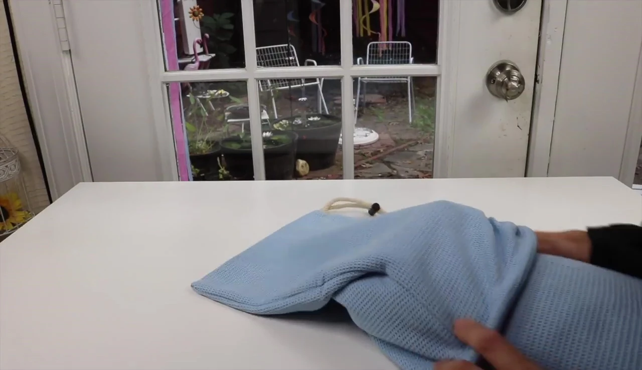 Putting the towel in the carrying bag