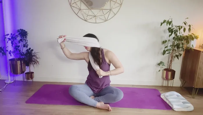 Hold opposite sides of the towel and pull in opposite directions, tilting your head to the side. Repeat on the other side. Be mindful not to over-pull.