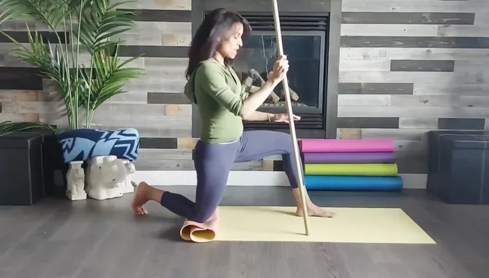 Lizard Pose with Stick (other side): Repeat step 5 with the right leg.