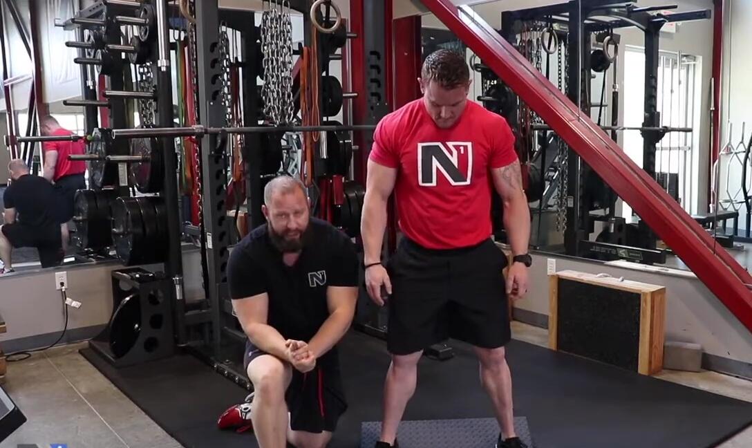 Adam performing a squat with a wider stance, showcasing increased hip mobility.