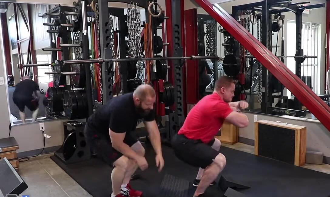 Adam performing a squat with heel elevation, demonstrating improved range of motion.