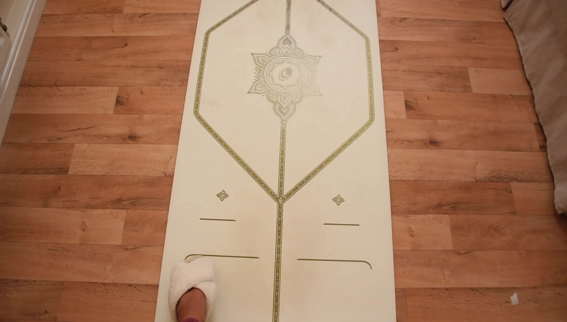 The yoga mat laid out showing the alignment markings.