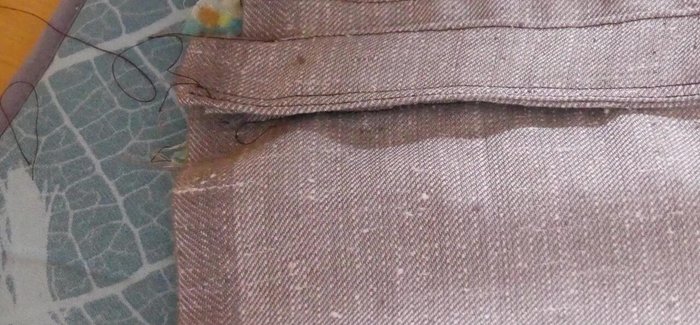 Attach the strap: Position the strap over the zipper ends, align raw edges, and pin to both main and inner fabric. Stay stitch both ends.