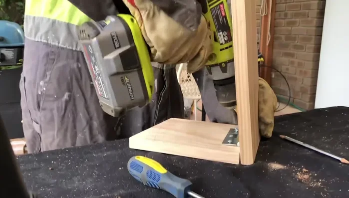 Attach the remaining legs to the seat, ensuring consistent angles.