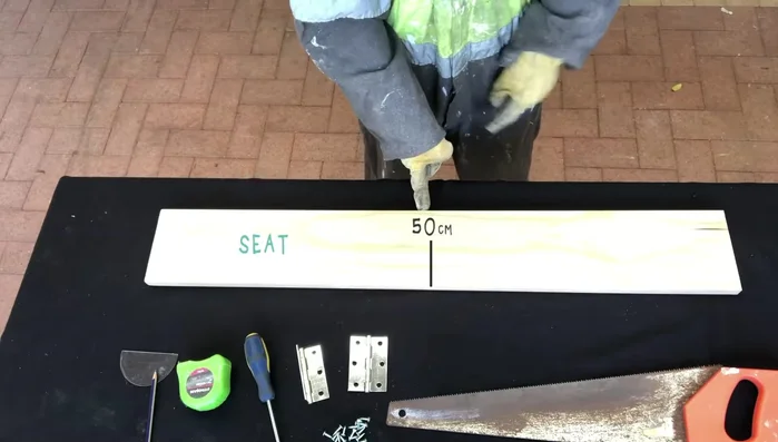 Use a saw to create straight cuts at right angles for the legs and seat.