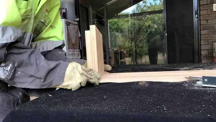 Pre-drill holes for screws to prevent wood splitting. Attach the hinge to the leg using screws.