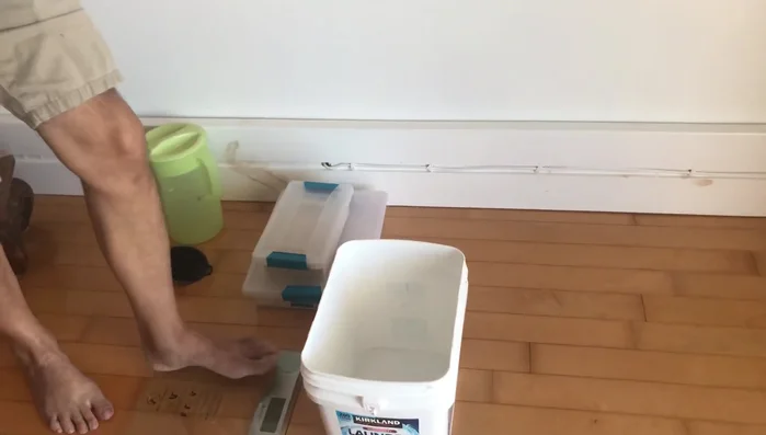 Pre-weigh the desired amount of sand (usually 8 or 10 pounds). The instructor weighed herself, then added the sand to find the correct weight.