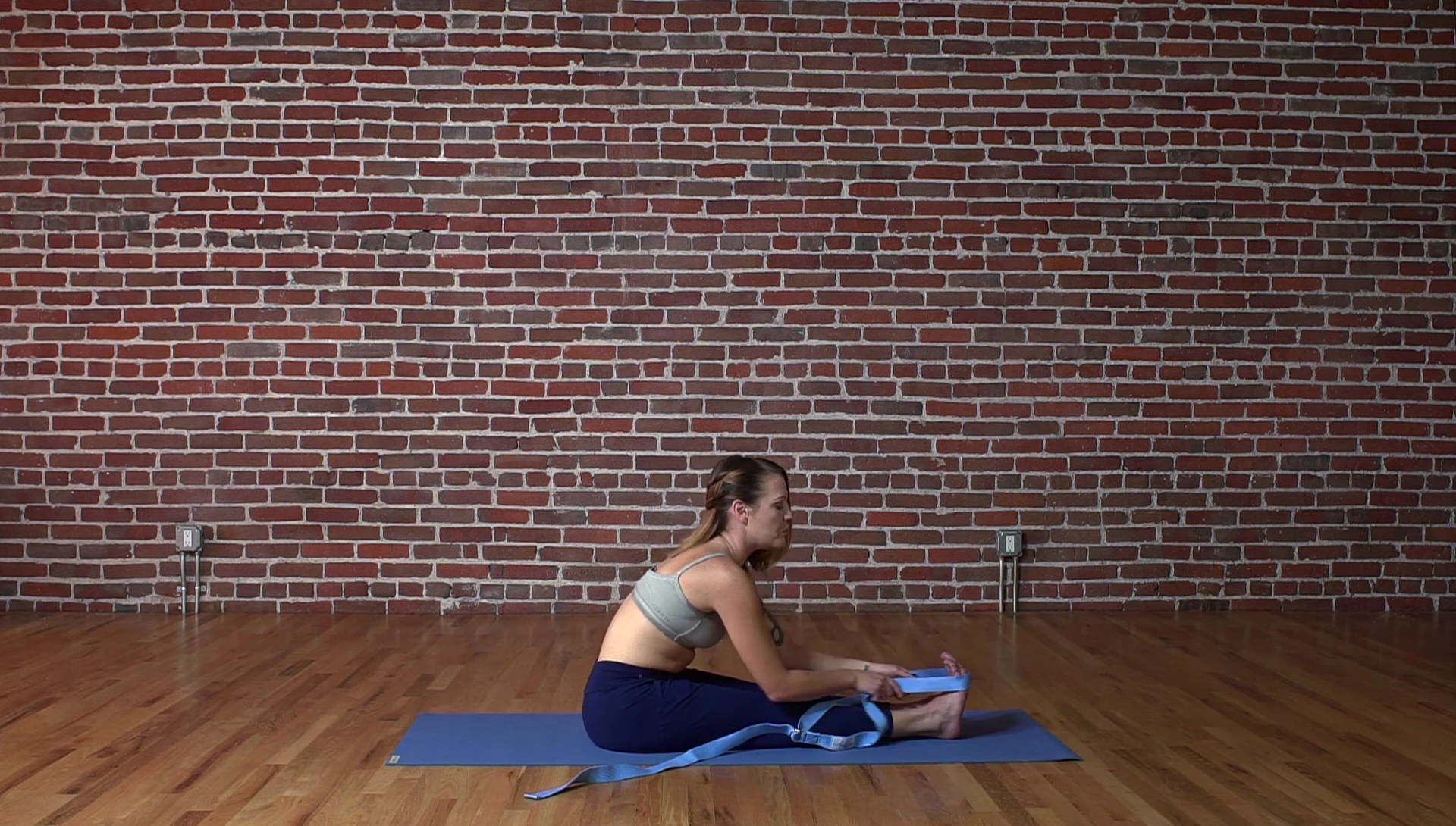 Close-up of woman's feet with yoga strap positioned correctly.