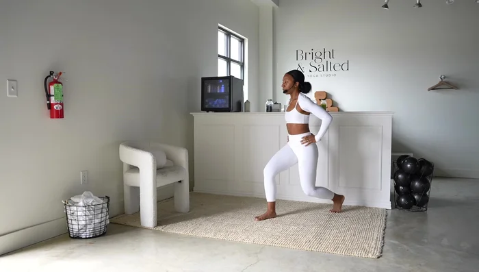 90/90 Stretch & Arm Open/Close: Step left leg back slightly into a 90/90 position. Extend arms forward, open left arm to the side, and press palms back, straightening through the legs.