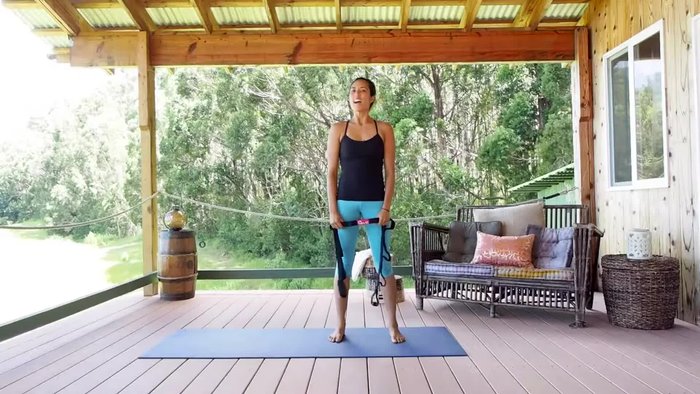 Sit up as straight as possible, holding the strap as far back as you comfortably can.