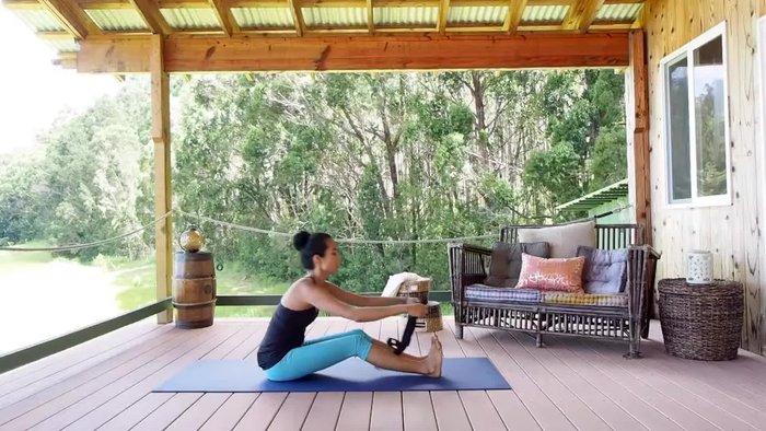 Walk your hands up the strap as needed, extending your arms as far as you can comfortably reach.