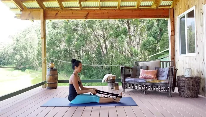 Walk your hands up the strap as needed, extending your arms as far as you can comfortably reach.