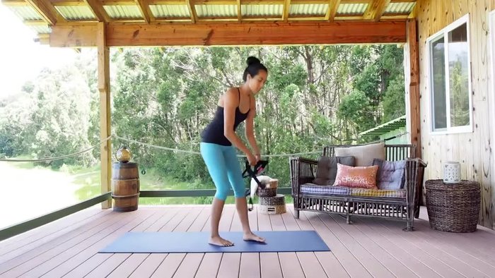 Sit up as straight as possible, holding the strap as far back as you comfortably can.