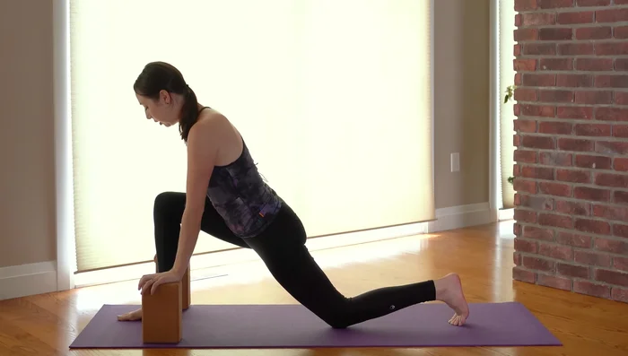 Extended Side Angle Pose (Utthita Parsvakonasana): Bend your front knee and deepen the triangle pose into an extended side angle pose. You can adjust block height as needed.