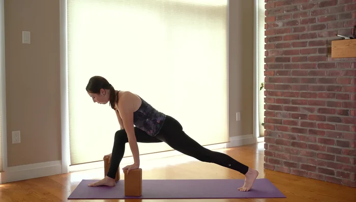 Extended Side Angle Pose (Utthita Parsvakonasana): Bend your front knee and deepen the triangle pose into an extended side angle pose. You can adjust block height as needed.