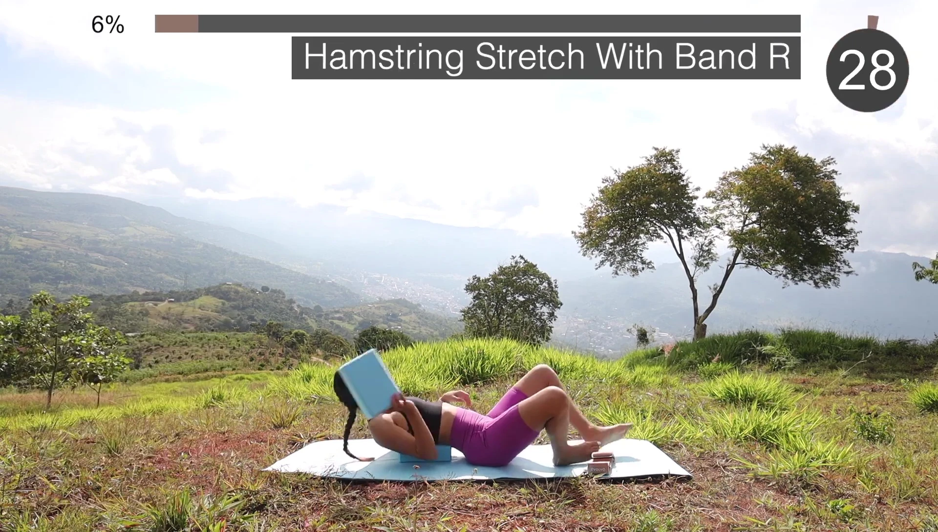 Person performing lying hamstring stretch with resistance band.