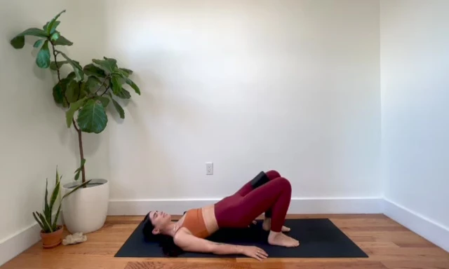 Woman performing a final calf raise and glute pulse.