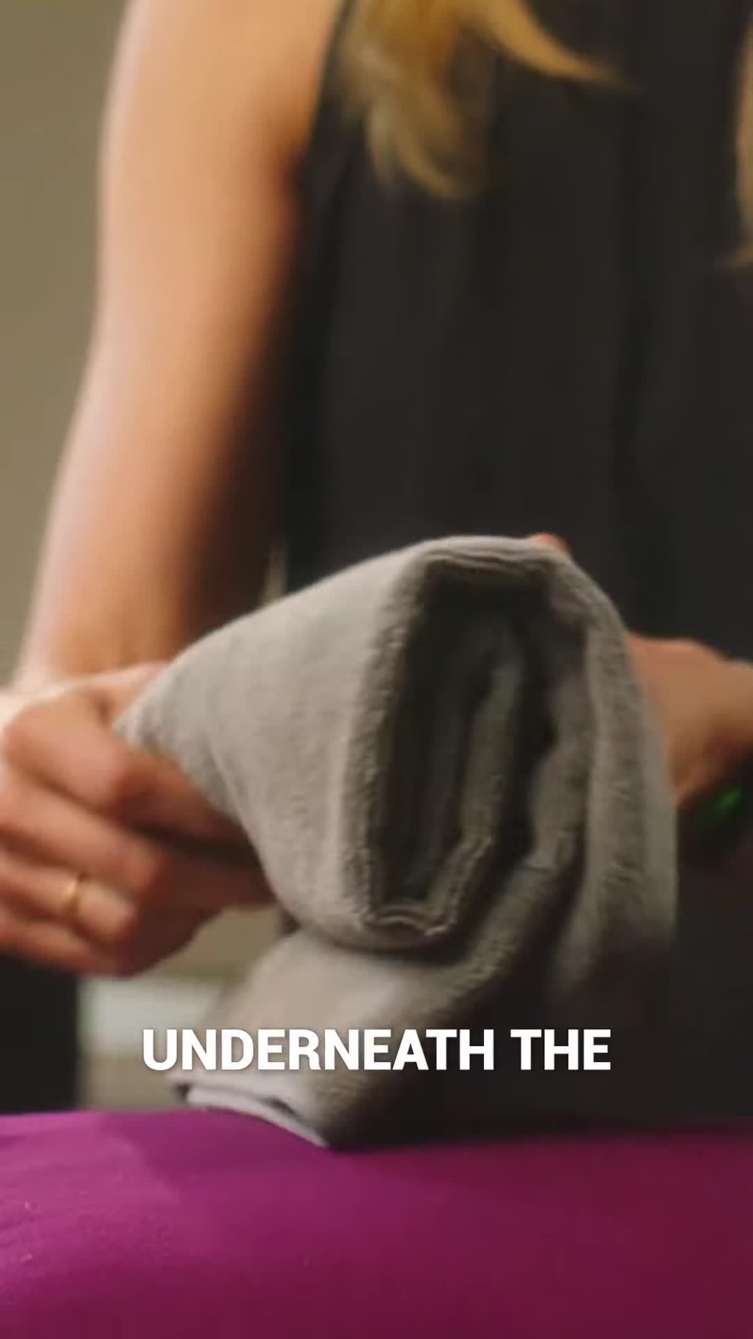 Close-up shot of towels rolled and placed under the neck for support
