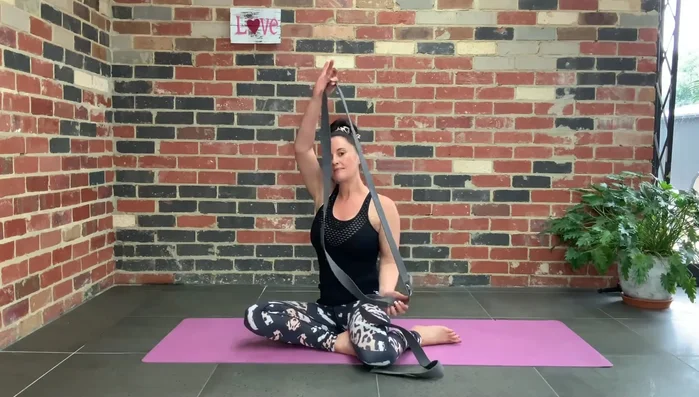 Place the strap under both feet, inside your legs.