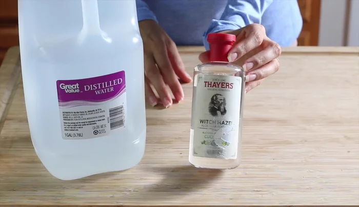 Prepare the base: Fill a spray bottle 3/4 full with distilled water, then top off with alcohol-free witch hazel, leaving room for essential oils.