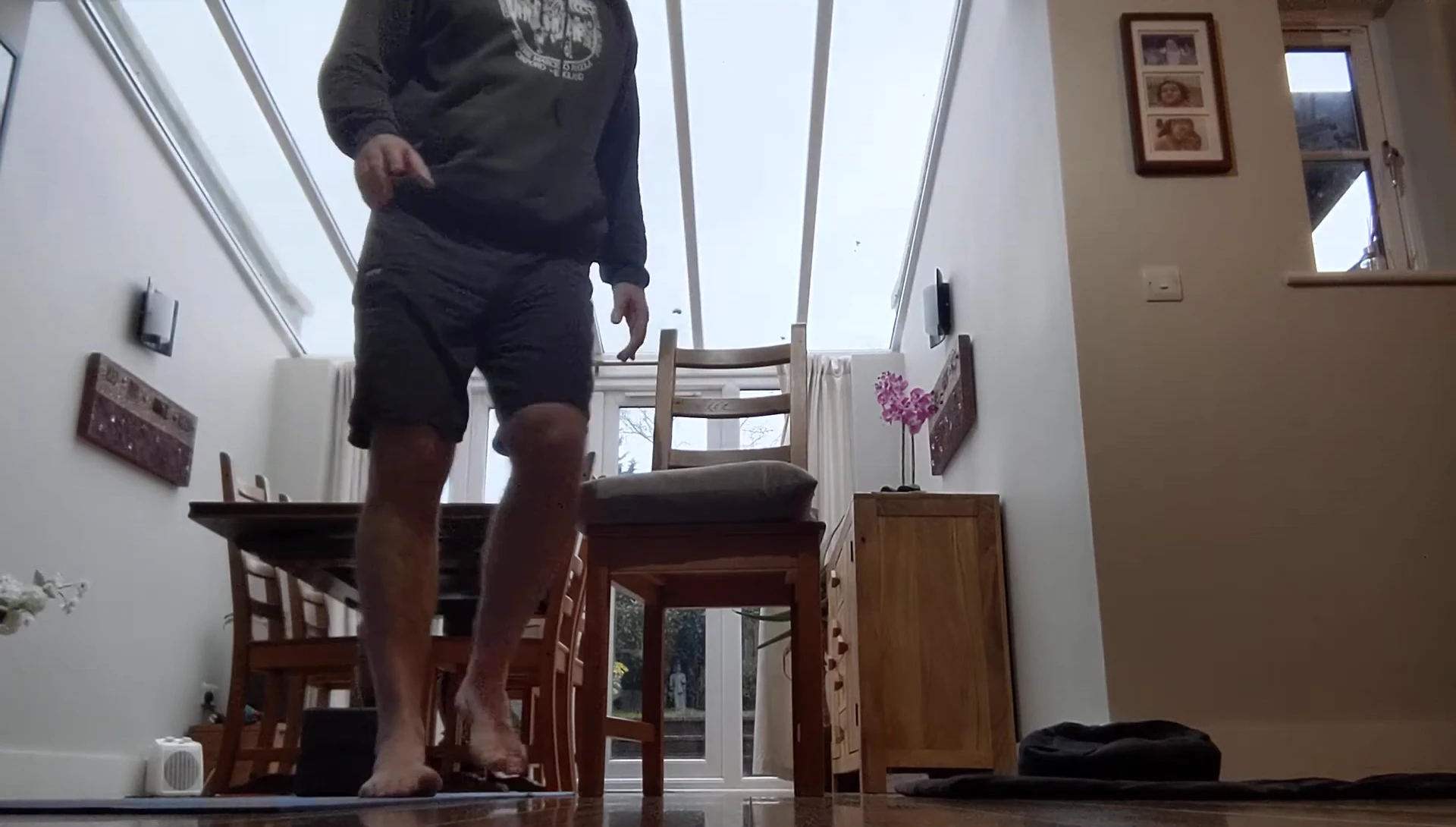 Person sitting comfortably in a chair with feet flat on the floor.
