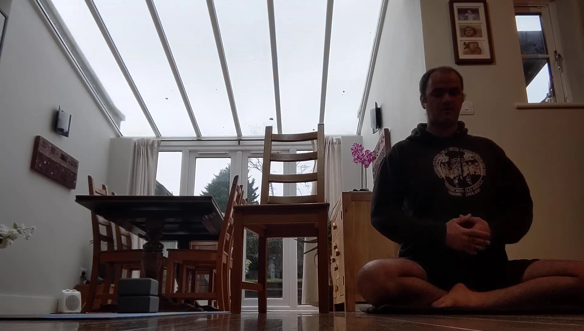 Demonstrates proper hand placement and posture with cushions.